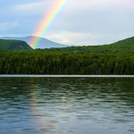 beautiful rainbow view over lake and mountains at a boys summer camp in New England